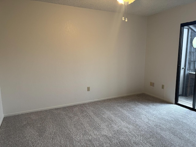 carpeted empty room with a textured ceiling