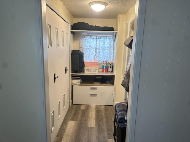 laundry room with dark hardwood / wood-style flooring and a textured ceiling