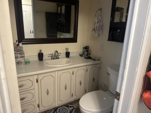 bathroom featuring decorative backsplash, vanity, and toilet