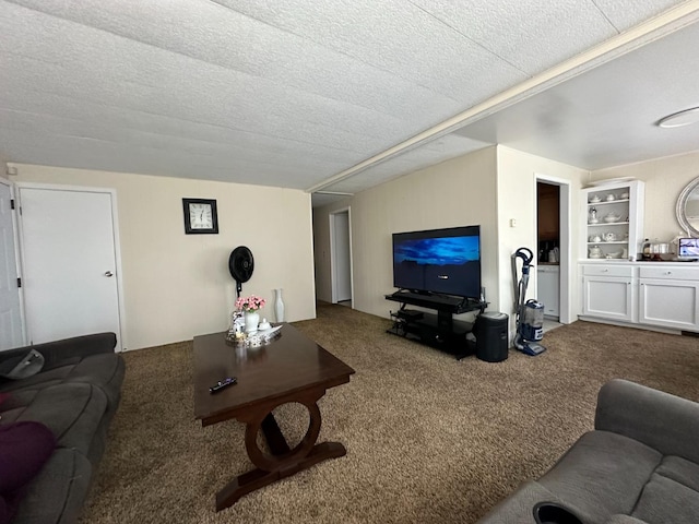 carpeted living room featuring built in shelves and a textured ceiling