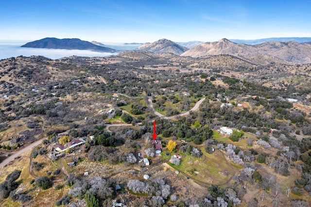 birds eye view of property with a water and mountain view