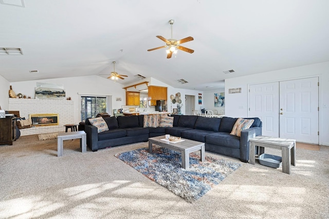 carpeted living room with a brick fireplace, ceiling fan, lofted ceiling, and sink