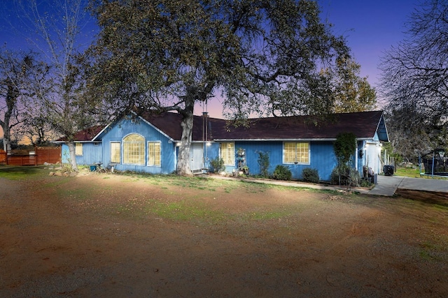 ranch-style home with a yard