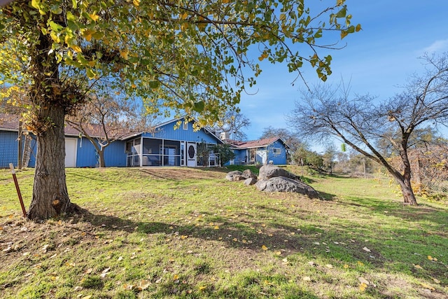 view of yard with a sunroom