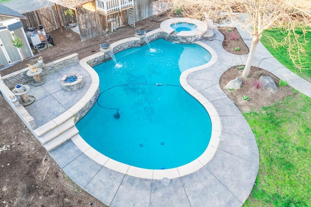 view of swimming pool featuring a fire pit, a patio, an in ground hot tub, and pool water feature