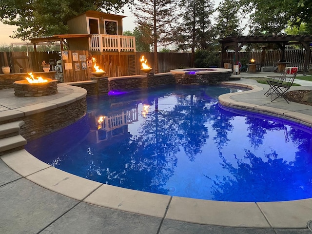 pool at dusk with a fire pit, a patio area, a pergola, and an in ground hot tub