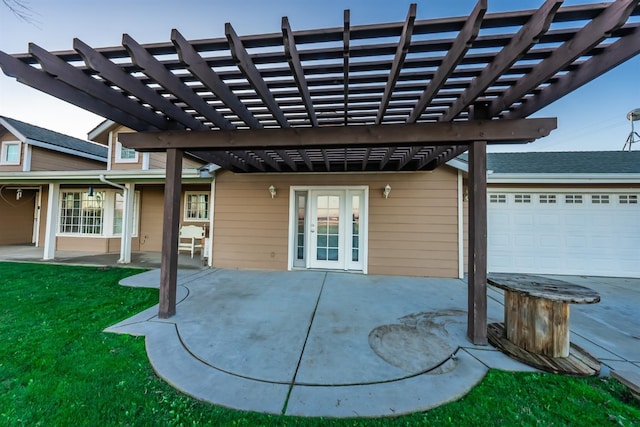 view of patio featuring a garage, a pergola, and french doors