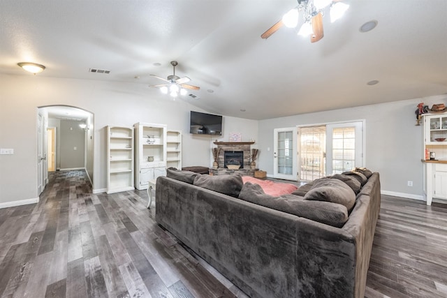 living room featuring lofted ceiling, ceiling fan, a fireplace, and dark hardwood / wood-style floors