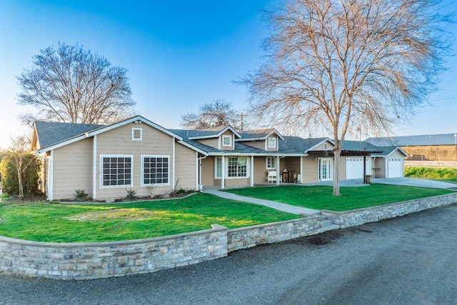 ranch-style house featuring a garage and a front lawn