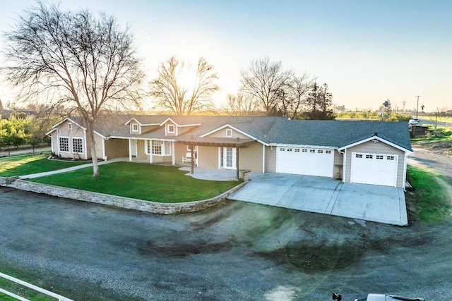 ranch-style house featuring a yard and a garage