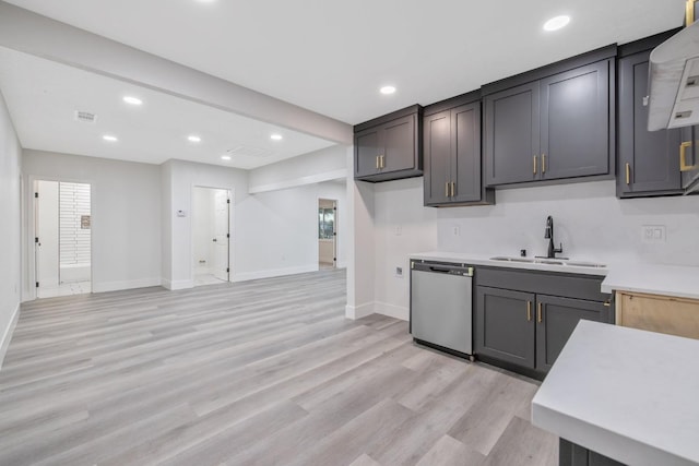 kitchen with light wood-type flooring, stainless steel dishwasher, and sink