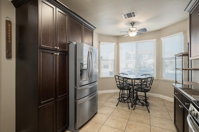 kitchen with ceiling fan, plenty of natural light, dark brown cabinets, and stainless steel appliances