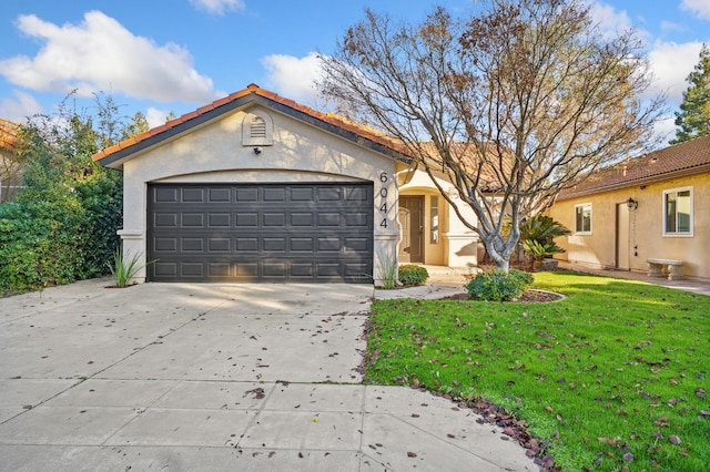 view of front facade featuring a front yard and a garage