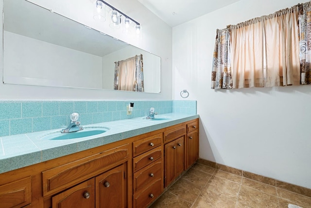 bathroom with vanity and tasteful backsplash