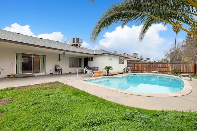 view of swimming pool with a yard, central AC, and a patio area