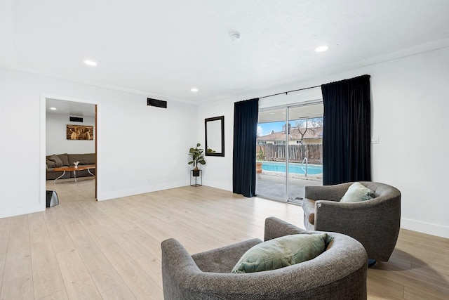 sitting room featuring light hardwood / wood-style flooring