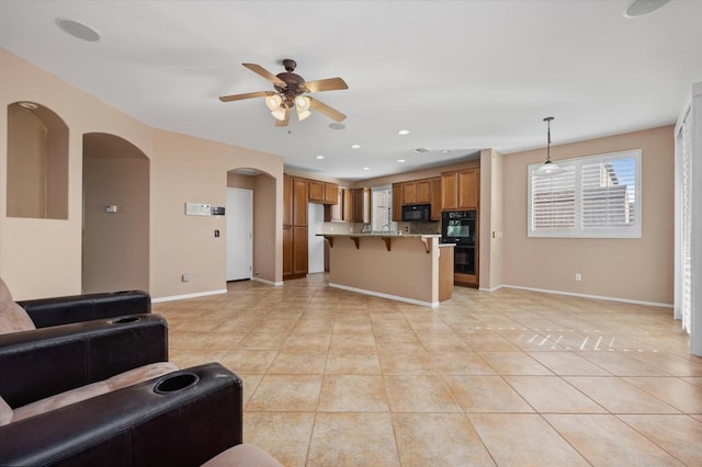 tiled living room with ceiling fan