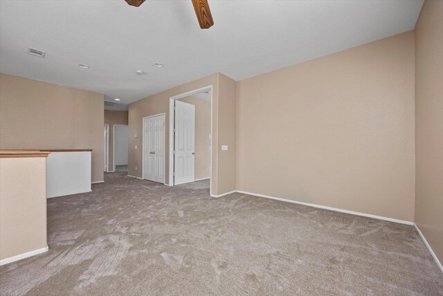 spare room with ceiling fan and carpet floors