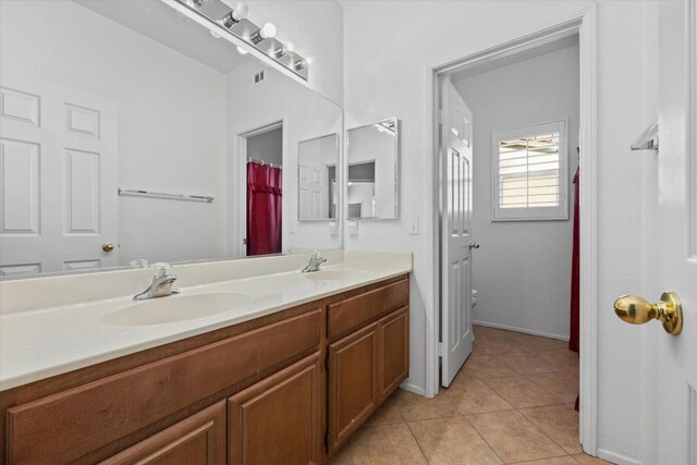 bathroom with tile patterned flooring and vanity