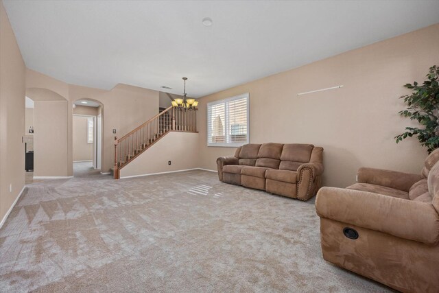 living room with light carpet and a chandelier