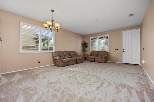 living room with a chandelier and light colored carpet