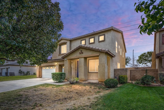 view of front of home with a yard and a garage