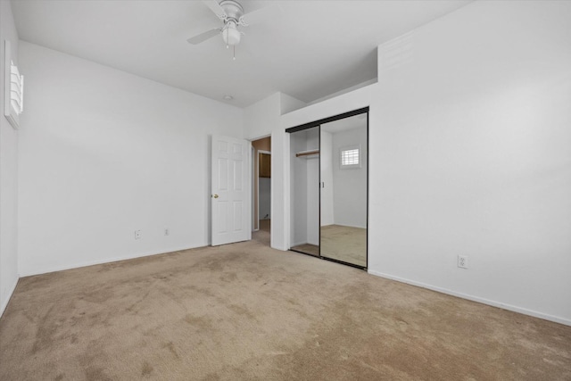 unfurnished bedroom featuring ceiling fan and light carpet