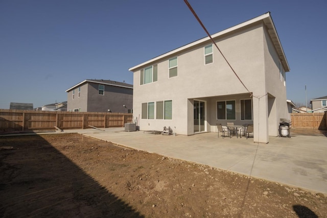 back of property featuring central air condition unit and a patio