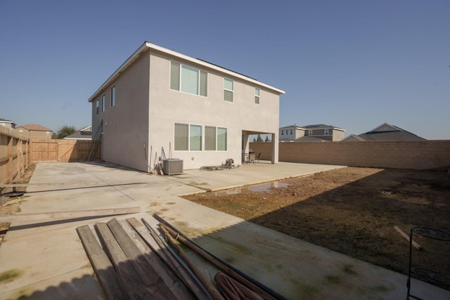 back of property featuring a patio area and central air condition unit