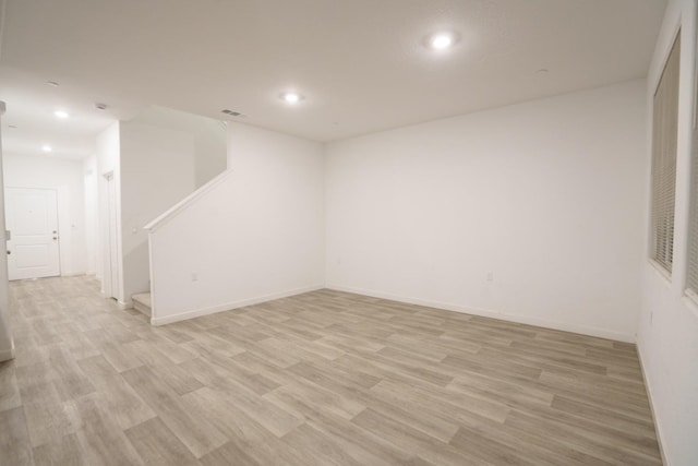 empty room with light hardwood / wood-style flooring