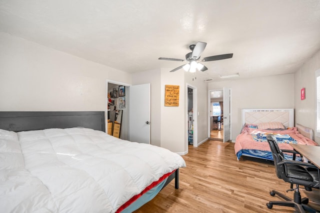 bedroom featuring hardwood / wood-style flooring, ceiling fan, and a closet