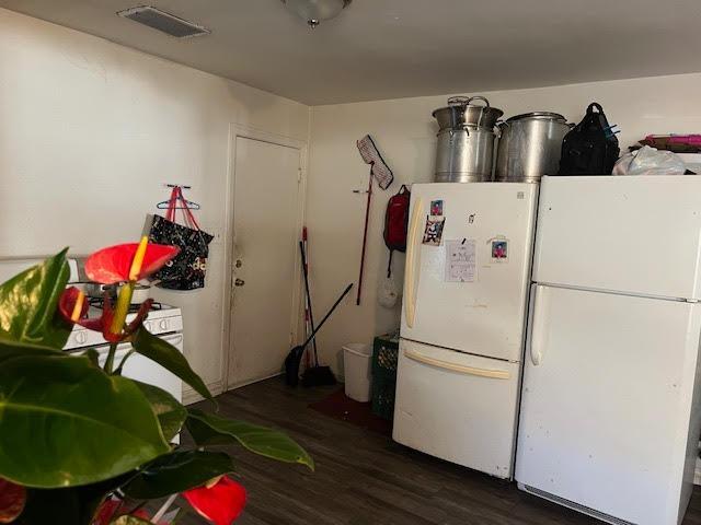 kitchen featuring dark hardwood / wood-style flooring and white refrigerator