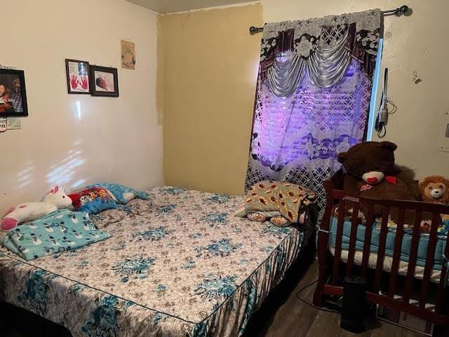 bedroom with hardwood / wood-style floors