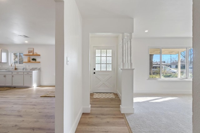 foyer with light hardwood / wood-style floors and sink