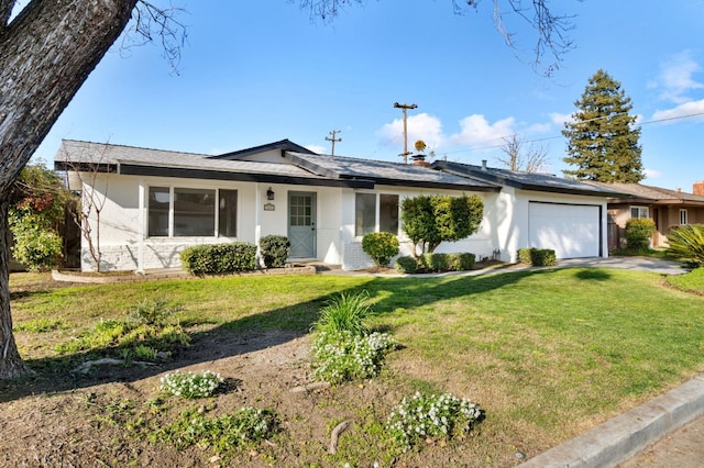 ranch-style house featuring a garage and a front yard