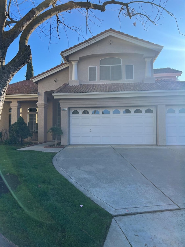 view of front of house with a garage and a front lawn