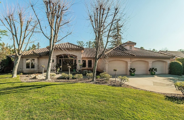 mediterranean / spanish-style home featuring a garage and a front lawn