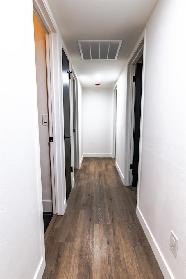 hallway featuring dark wood-type flooring