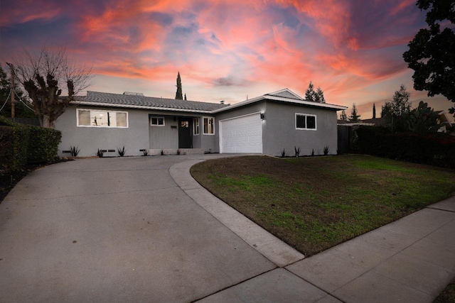 view of front of home with a lawn and a garage