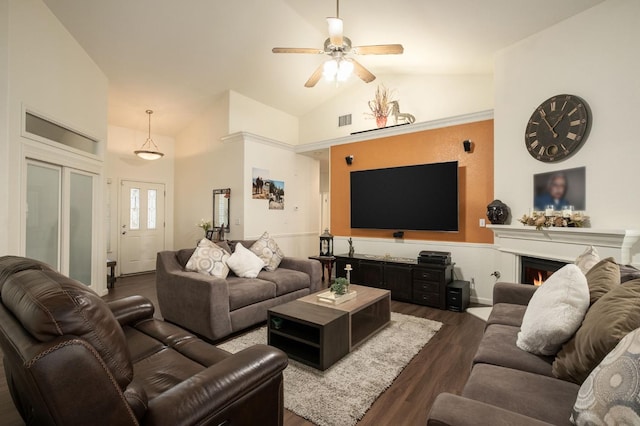 living room featuring vaulted ceiling, ceiling fan, and dark wood-type flooring