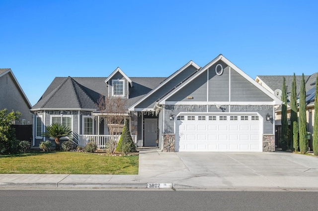 view of front of property featuring a garage and a front lawn