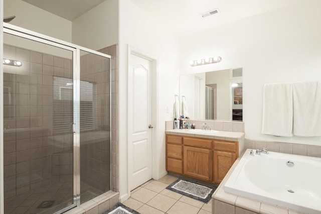 bathroom with tile patterned floors, separate shower and tub, and vanity