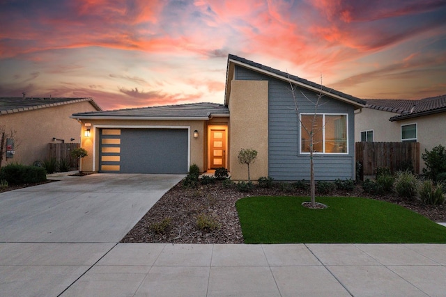 view of front of home featuring a lawn and a garage