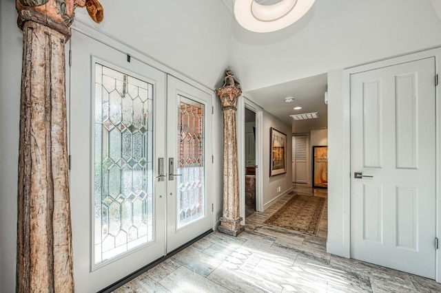 doorway to outside featuring ornate columns and french doors