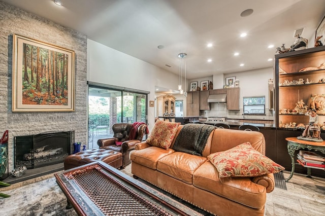 living room featuring a stone fireplace