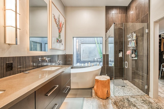 bathroom with backsplash, vanity, shower with separate bathtub, and tile walls