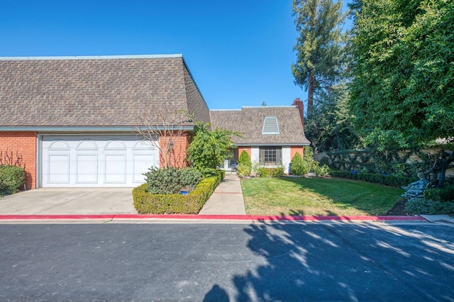 view of front of home featuring a front yard, a shingled roof, a garage, concrete driveway, and brick siding
