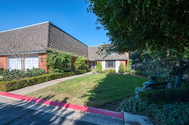 view of front of property with a garage and a front lawn