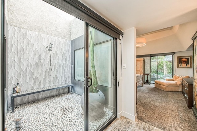 full bathroom featuring ensuite bath, baseboards, and a stall shower