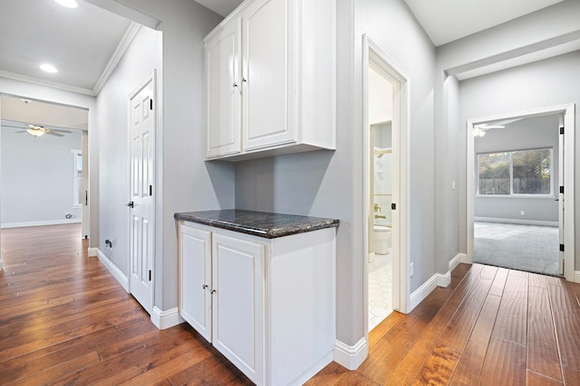 corridor featuring crown molding and dark hardwood / wood-style floors